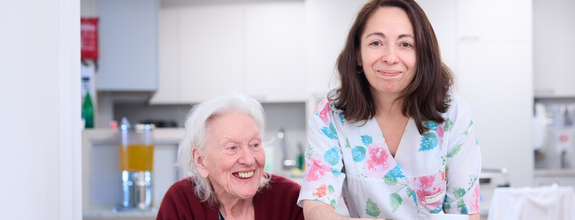 Caritas - Employer Branding 2024 Eine Caritas Pflegekraft bringt einer Caritas Kundin eine Tasse Tee